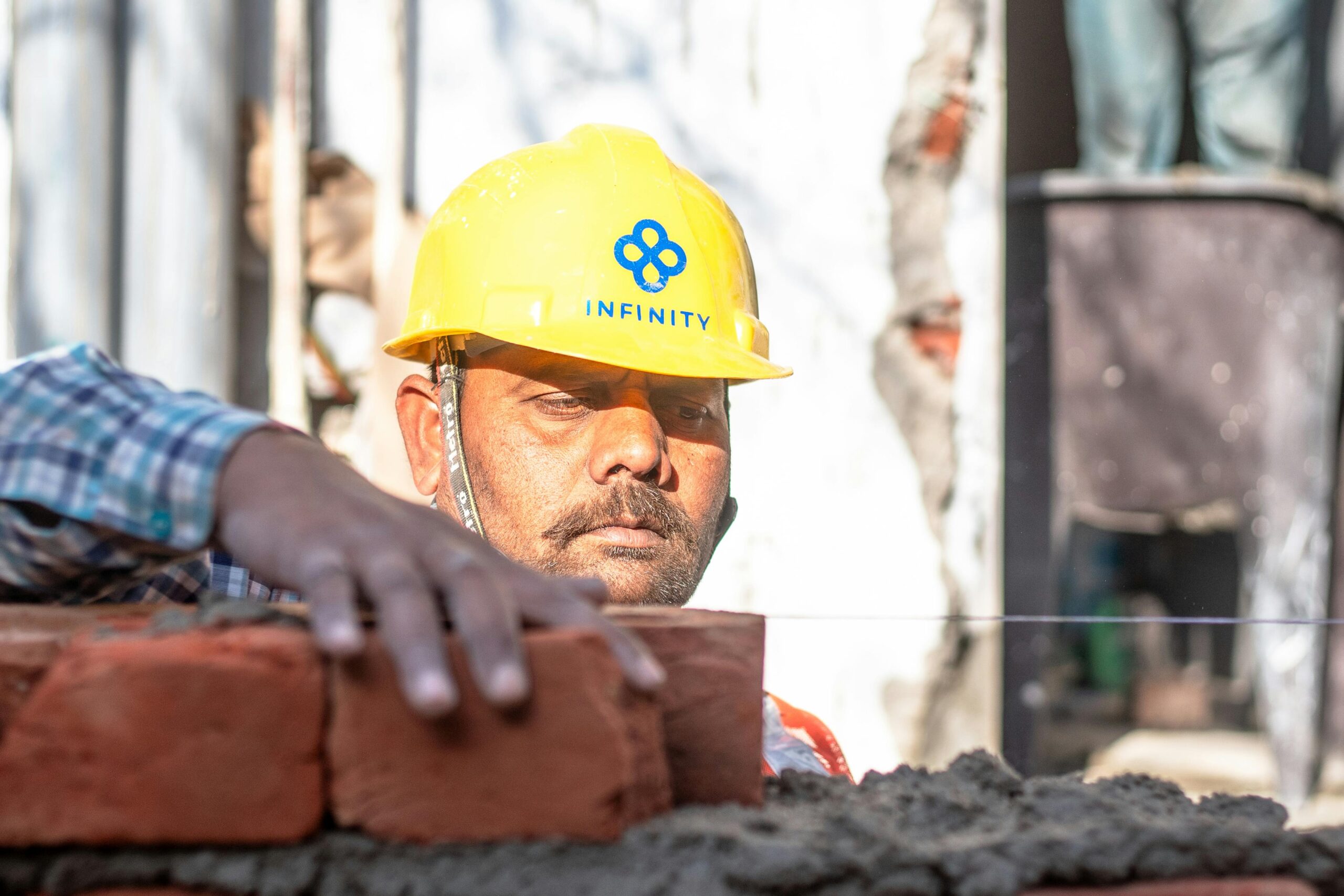 pexels-photo-30580527-30580527 A construction worker carefully aligning bricks on a wall in Delhi, India.